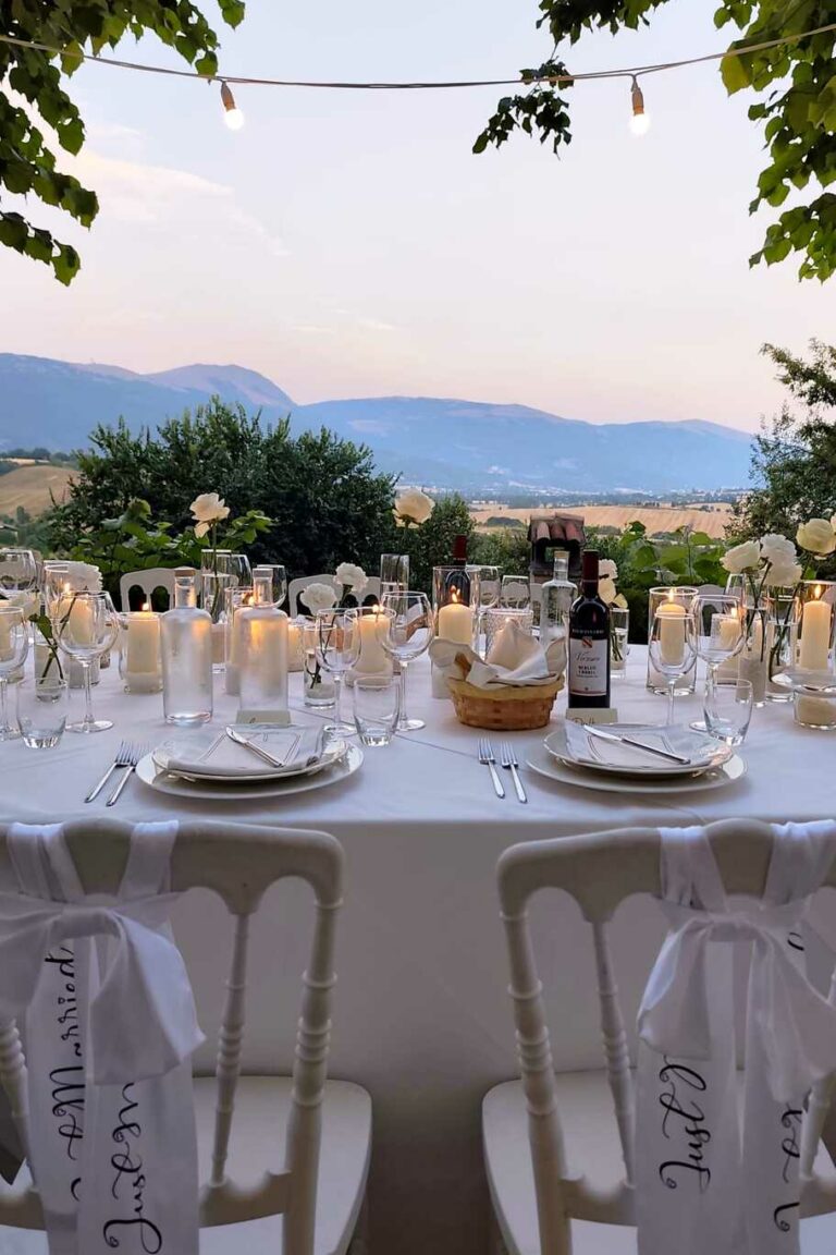 cena con decorazioni romantiche e candele al tramonto con vista nella vallata e colline umbre del castello di baccaresca